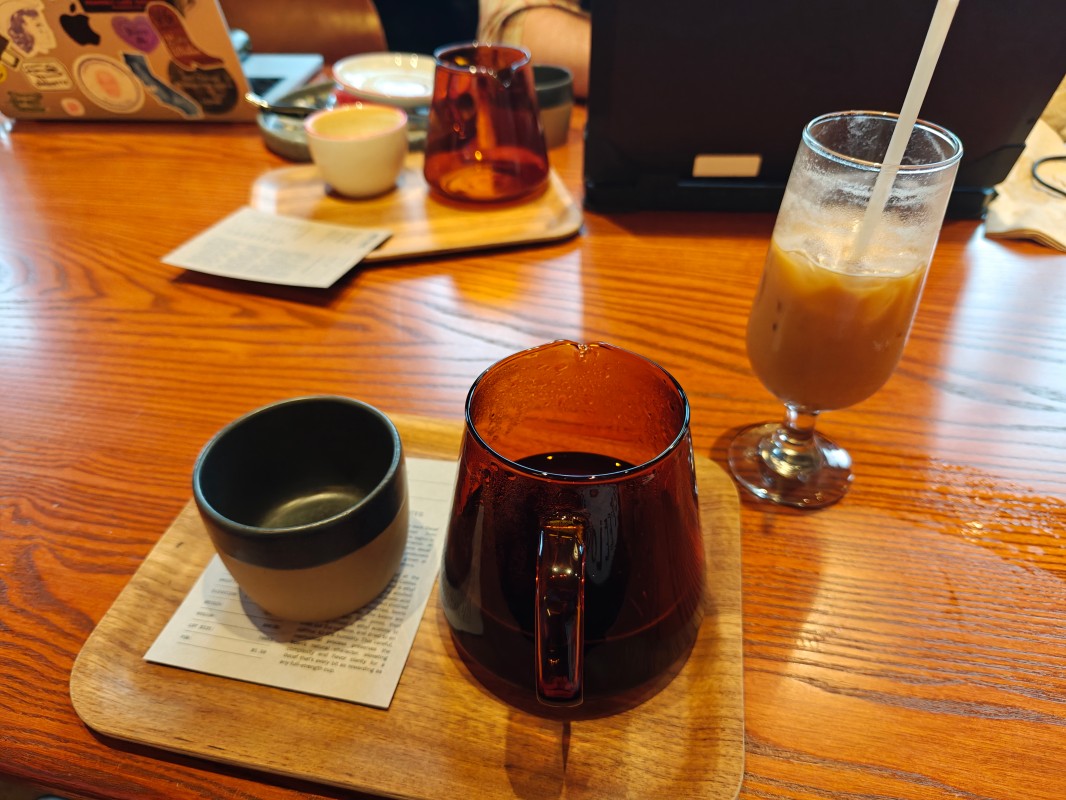 A picture of a pour over and a bubbly beverage in a stemmed glass